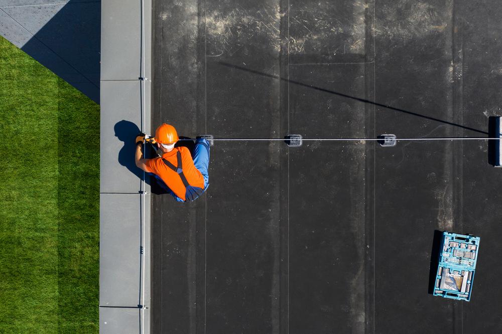 EPDM commercial flat roof maintenance with fall protection system